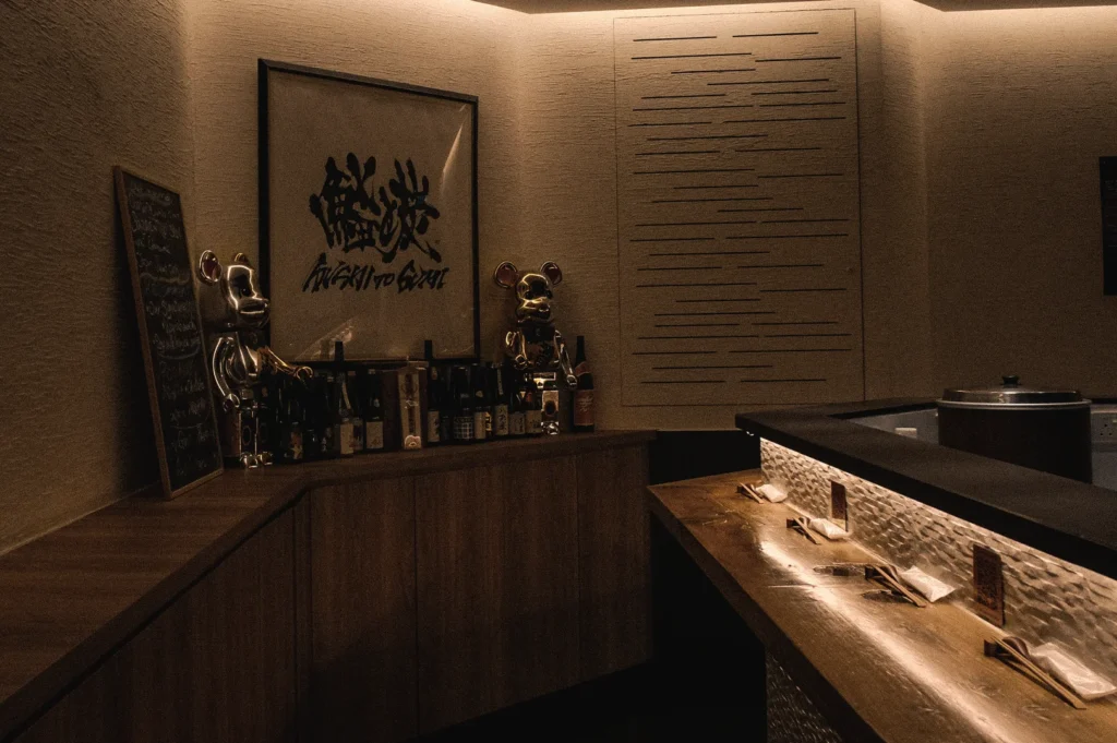 Wide-angle view of Sushi To Sumi's intimate standing sushi bar, featuring handcrafted wood interiors, counter seating, and a traditional Japanese dining atmosphere.